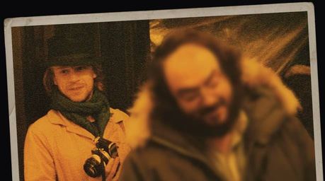 A picture of Leon Vitali, with Stanly Kubrick out of focus in the foreground.