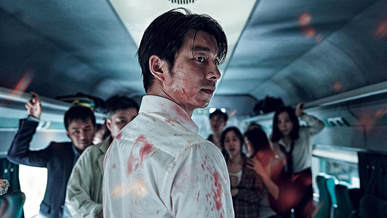Seek-Woo covered in blood in Train to Busan. A more subtle representation of corporate greed, and complicit guilt